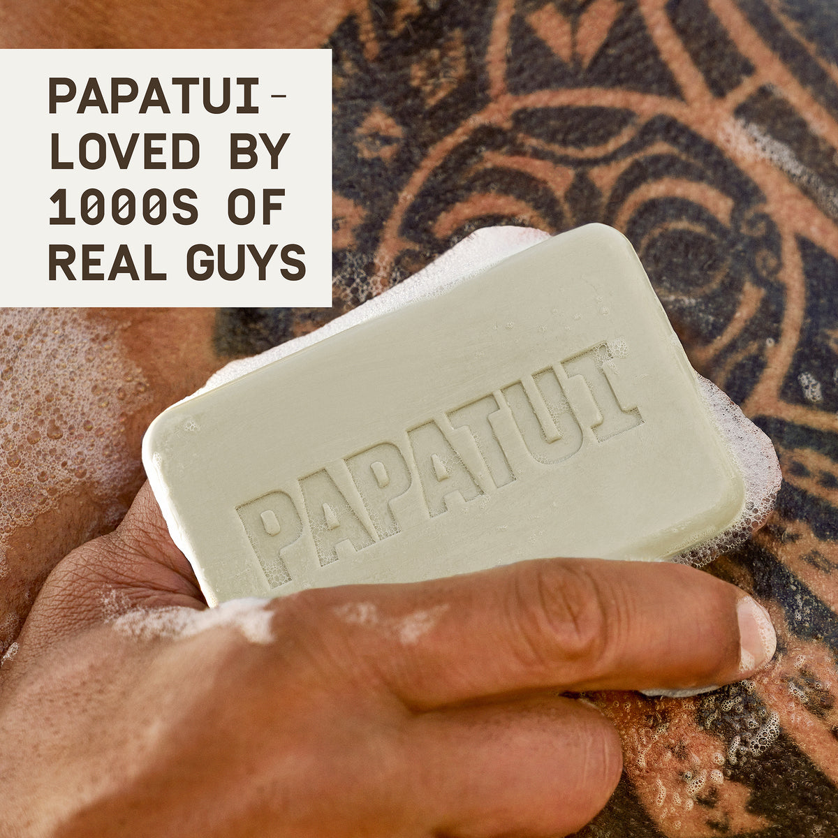 This image shows the cedar sport enriching bar soap lather on Dwayne "The Rock" Johnson's tattoo with text that reads "papatui loved by 1000s of real guys."