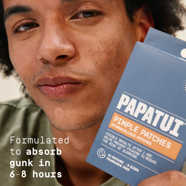 Man holding Papatut pimple patches with product packaging in the foreground and text reading "formulated to absorb gunk in 6-8 hours."