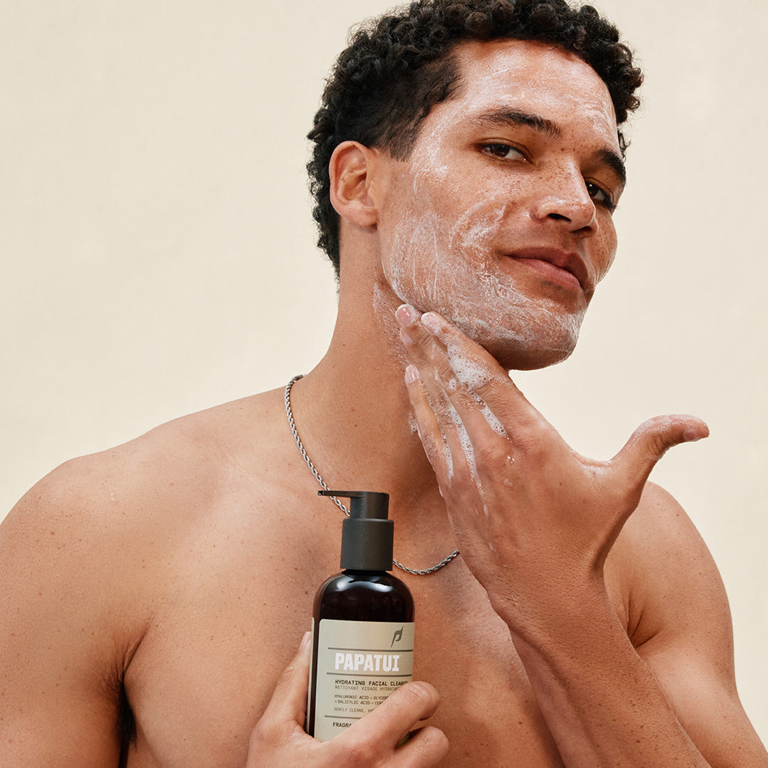 Man applying PAPATUI Hydrating Facial Cleanser to his face against a neutral background