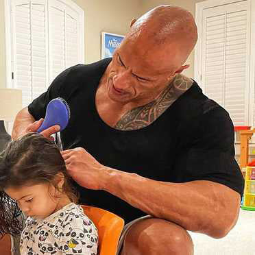 Dwayne "The Rock" Johnson combing little girl's hair