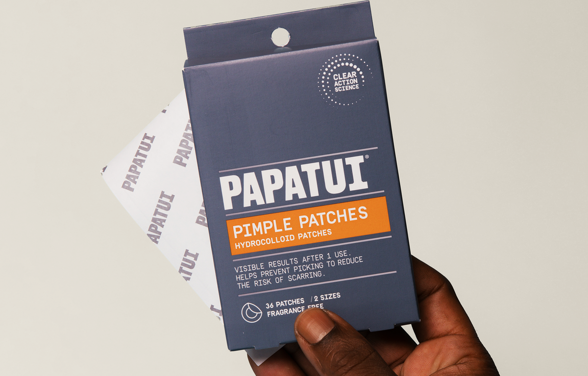 PAPATUI Pimple Patches packaging held by a hand against a neutral background