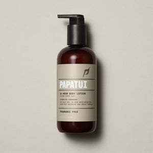 A bottle of men's body lotion placed on a clean surface. The lotion is specifically formulated for men's skin and is labeled with its brand and skin benefits. The packaging is sleek and masculine, often in darker colors or with minimalist design.